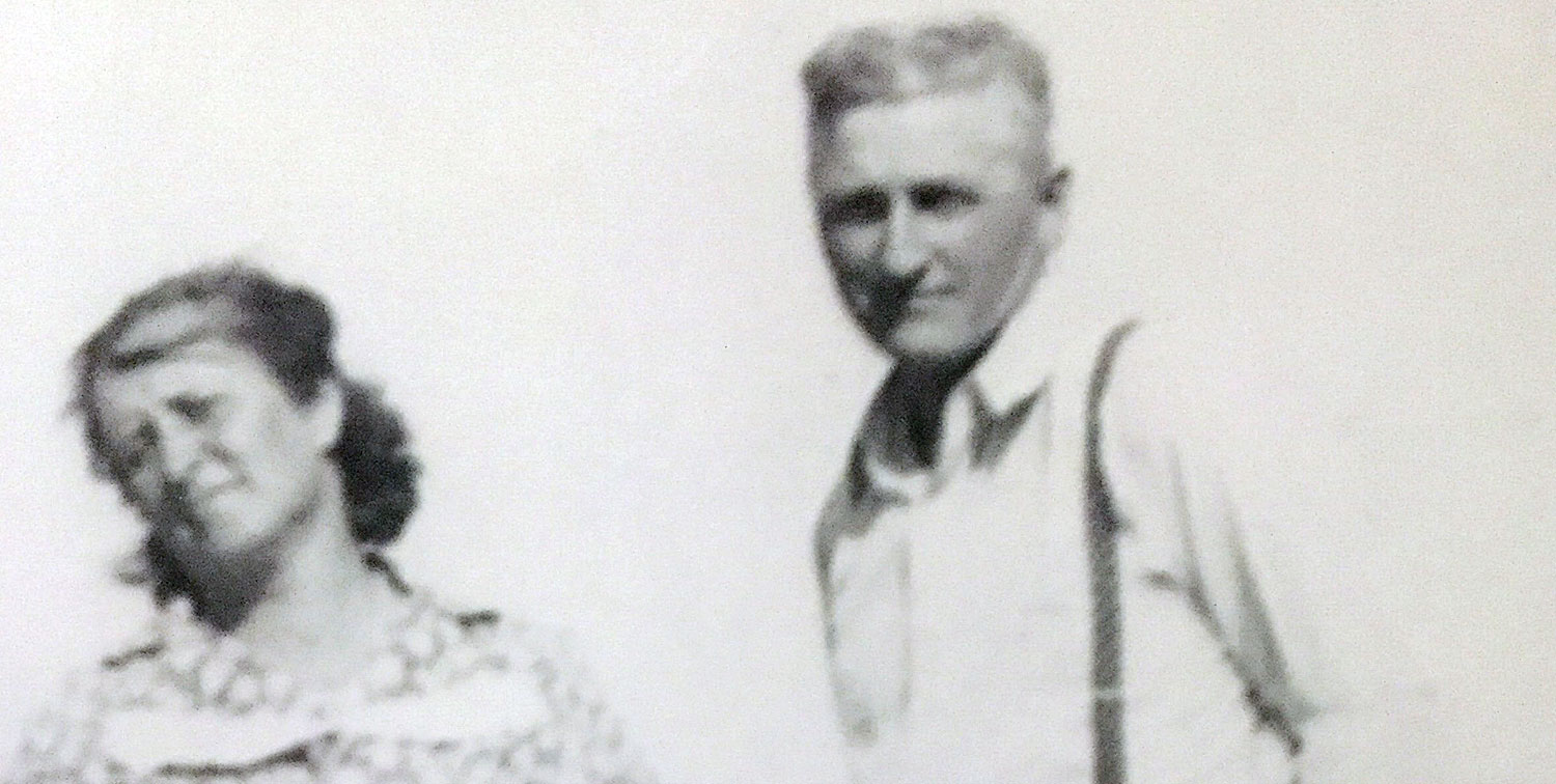 Snapshot of Mary Jessie (Cluckey) Haverkamp and Herman John Haverkamp Jr. standing outside on a farm, probably in the 1930s