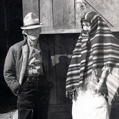 Snapshot of W. F. Murphy Sr. and Ruby (Wolf) Murphy standing in front of a barn, taken in the 1930s or '40s