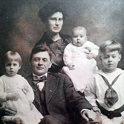 Studio portrait of Fred Pfeifer and Nellie (Logan) Pfeifer with children (from left) Charlotte, Eleanor, and Forest, taken around 1918