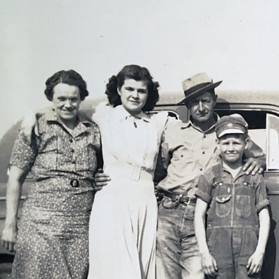 Snapshot of Hazel (Rodgers) Rager and Walter Rager standing in front of a car with children Wanda and Walter (son Robert not pictured), taken Easter Sunday, 13 Apr 1941