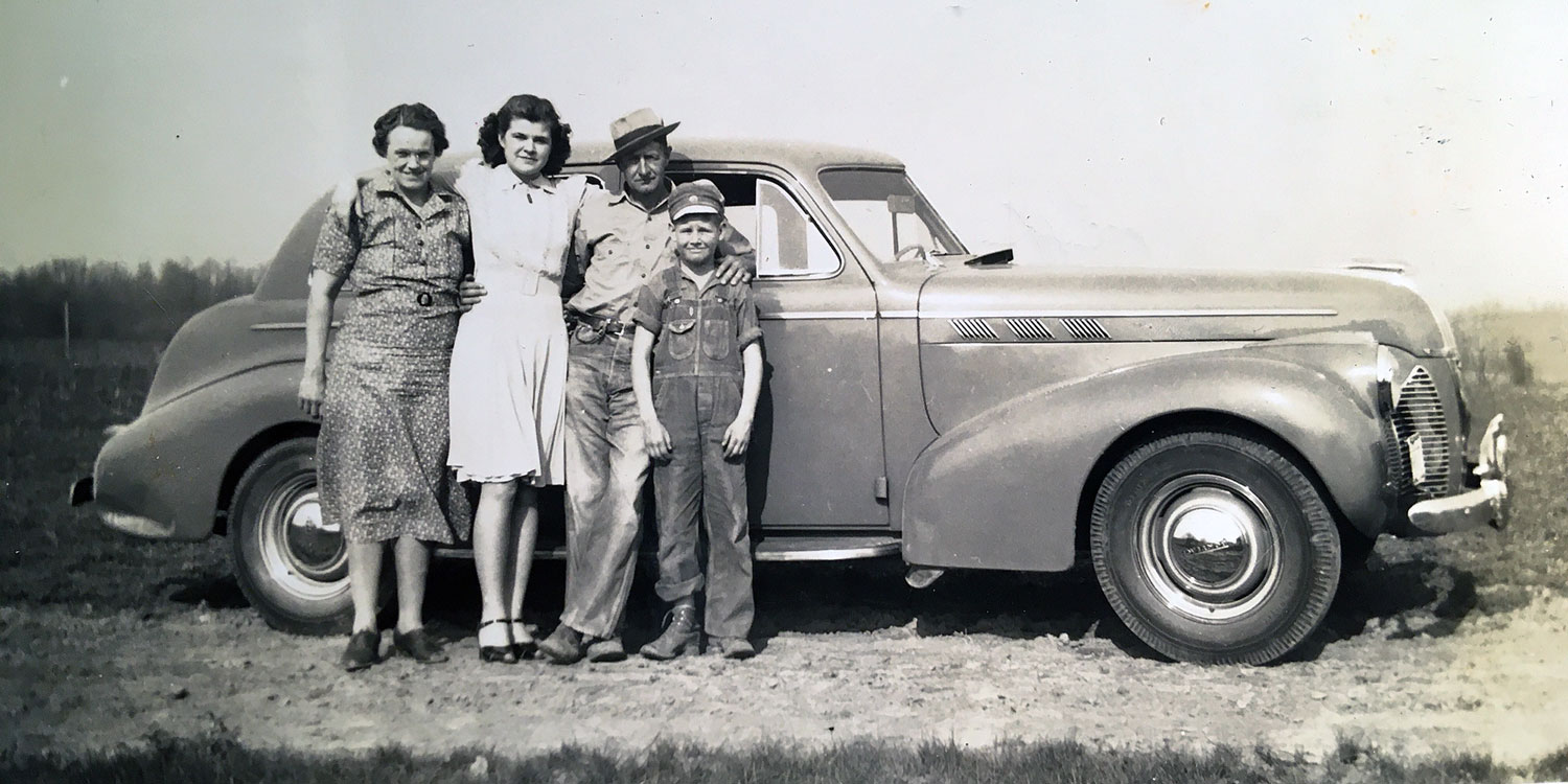 Snapshot of Hazel (Rodgers) Rager and Walter Rager standing in front of a car with children Wanda and Walter (son Robert not pictured), taken Easter Sunday, 13 Apr 1941